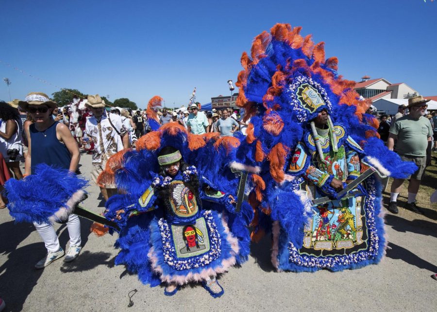 Two members of the 9th Ward Black Hatchet Mardi Gras Indians parade through the New Orleans Jazz Heritage Festival. A centuries-old African-American practice, Mardi Gras Indians have come under scrutiny for their adoption of Native American garb. Practitioners named themselves after natives because of historical native assistance in escaping slavery.