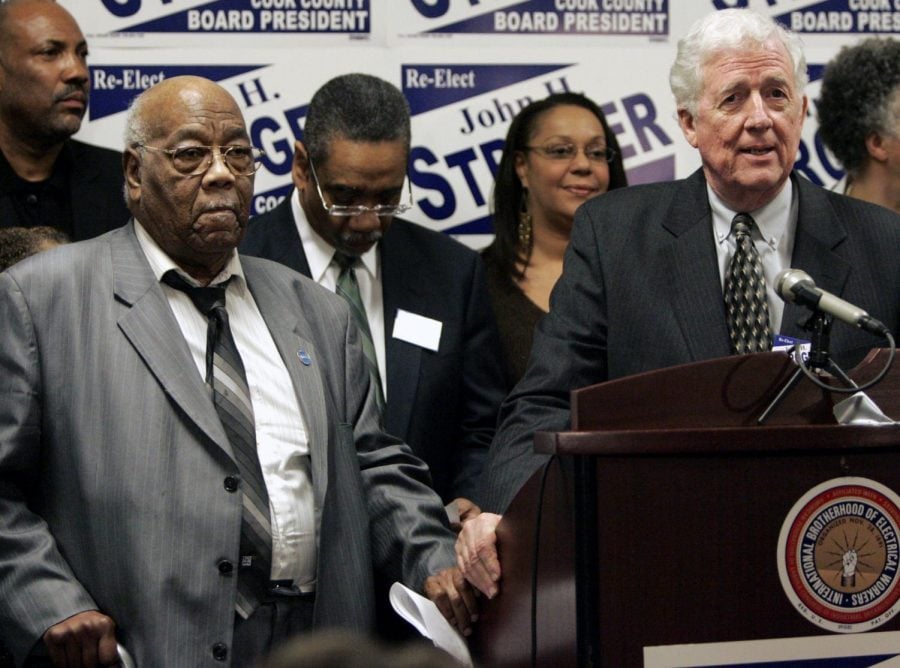 In this Wednesday, March 22, 2006 file photo, Cook County Board President John H. Stroger campaign co-chairs Dr. Robert Johnson, left, and Thomas Hynes, right, speak at a news conference in Chicago. Former Illinois state Senate president and Democratic National Committee member Thomas Hynes, who was a powerhouse in Chicago politics for four decades, has died. He was 80. His son Dan Hynes confirmed that Thomas Hynes died earlier Saturday, May 4, 2019 at Northwestern Memorial Hospital from complications of Parkinson’s Disease.