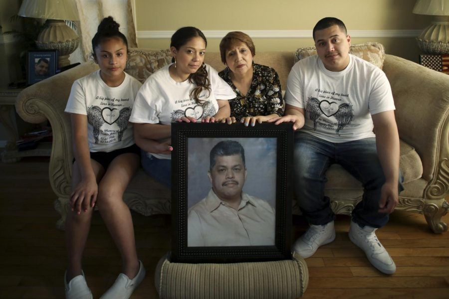 In this Wednesday, May 22, 2019 photo, family members of Vicente Juarez, including from left to right, his granddaughter Dyani (cq), 12, daughter Diana, wife Leticia and son Christian, pose for a photograph with a portrait of Juarez at their home in Oswego, Ill. Juarez was one of five people fatally shot by a coworker on Feb. 15 at the Henry Pratt Co. in Aurora. A Chicago Tribune investigation suggests that tens of thousands of Illinois residents whose gun licenses have been revoked could still have firearms. The problem was underscored in Februarys Aurora shooting when the shooter used a gun he kept despite the revocation of his Firearm Owner’s Identification card in 2014.