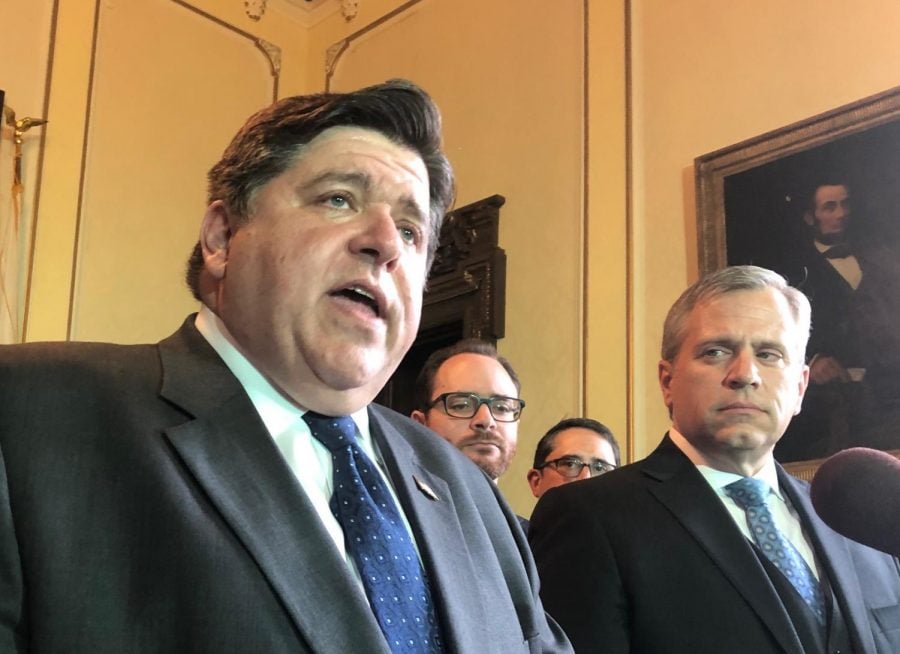 Democratic Gov. J.B. Pritzker, left, discusses the House action to put a constitutional amendment to implement Pritzkers graduated income tax on the November 2020 ballot in Springfield, Ill., Monday, May 27, 2019. Voters decide whether to eliminate Illinois flat-rate tax system which critics claim is regressive. Rep. Robert Marwick, D-Chicago, the sponsor of the amendment which underwent nearly 3 ½ hours of debate on the House floor, looks on. 
