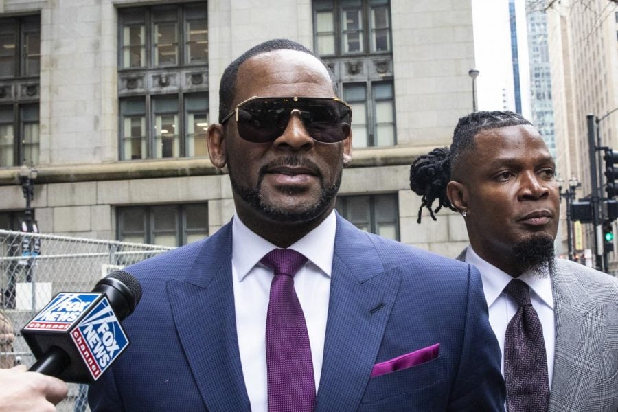 This March 13, 2019 file photo shows R. Kelly and his publicist Darryll Johnson, right, leaving The Daley Center after an appearance in court for Kellys child support case in Chicago. Prosecutors in Chicago have charged Kelly with 11 new sex assault charges, some that are more serious than those first filed against him in February. The Chicago Sun-Times reported Thursday, May 30, on its website that the charges include counts that carry a potential sentence of up to 30 years in prison. The charges say the alleged offenses happened in 2010.