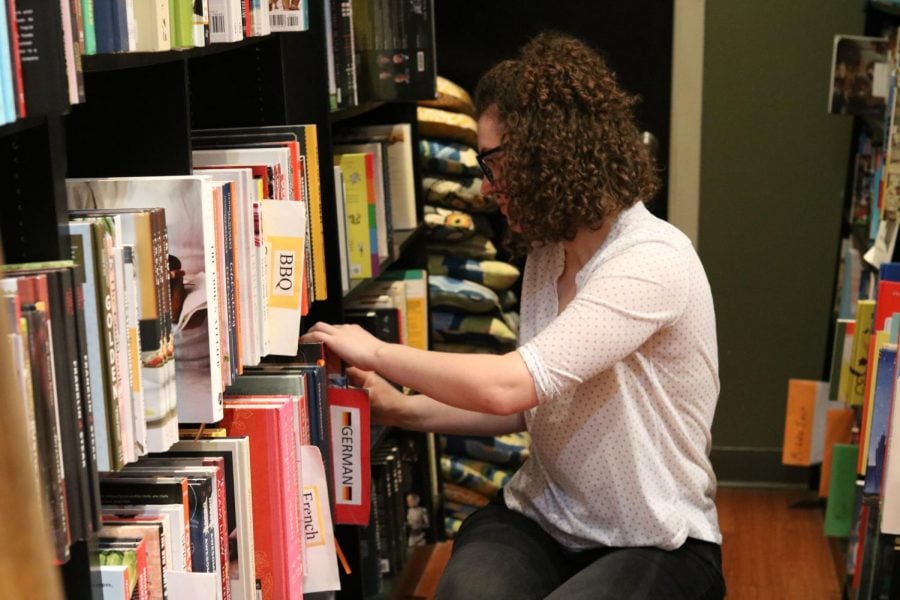 A customer looks for a book at The Book Cellar.