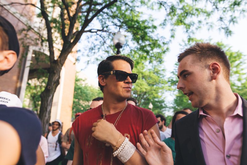 Milo Yiannopoulos (left) and John Minster (right), then the president of DePaul College Republicans, exit the Student Center following the disruption of the 2016 Yiannopoulos event.