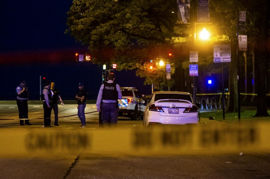 In this Saturday, June 1, 2019 photo, Chicago police investigate the scene where multiple people were shot in the Gold Coast neighborhood of Chicago.