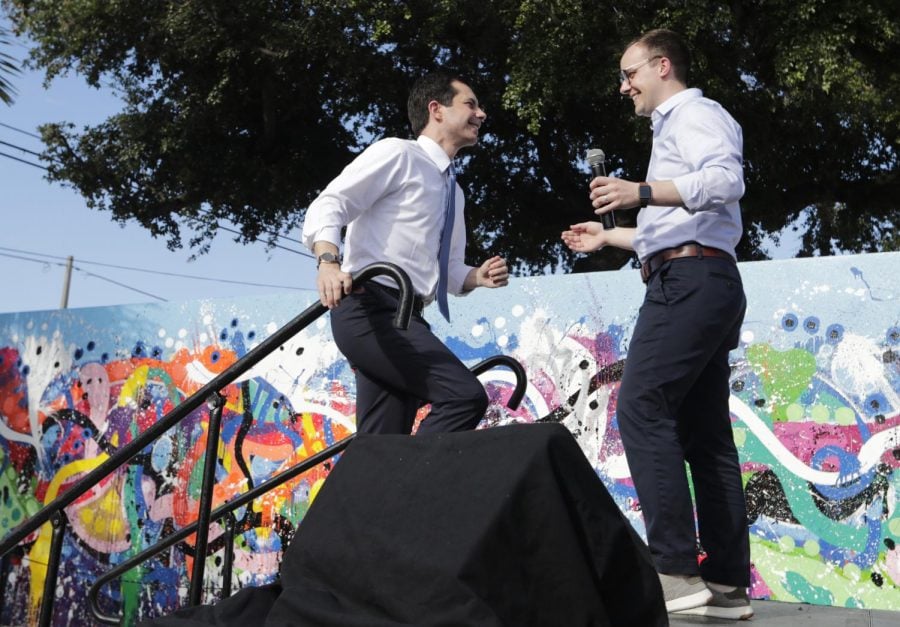 In this May 20, 2019, file photo, Democratic presidential candidate Pete Buttigieg, the mayor of South Bend, Ind., left, is introduced by his husband Chasten Buttigieg, right, during a fundraiser at the Wynwood Walls, in Miami. Buttigieg knows firsthand the burden of six-figure student loan debt. He and his husband have loans of more than $130,000, placing them in the ranks of the 43 million Americans who owe federal student debt.