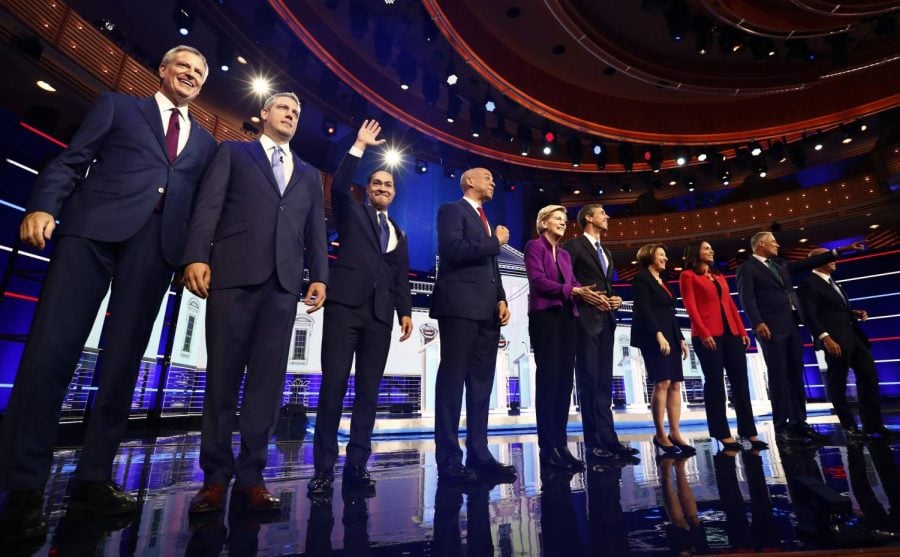 From left, New York City Mayor Bill de Blasio, Rep. Tim Ryan, D-Ohio, former Housing and Urban Development Secretary Julian Castro, Sen. Cory Booker, D-N.J., Sen. Elizabeth Warren, D-Mass., former Texas Rep. Beto O Rourke, Sen. Amy Klobuchar, D-Minn., Rep. Tulsi Gabbard, D-Hawaii, Washington Gov. Jay Inslee, and former Maryland Rep. John Delaney pose for a photo on stage before the start of a Democratic primary debate hosted by NBC News at the Adrienne Arsht Center for the Performing Arts, Wednesday, June 26, 2019, in Miami.