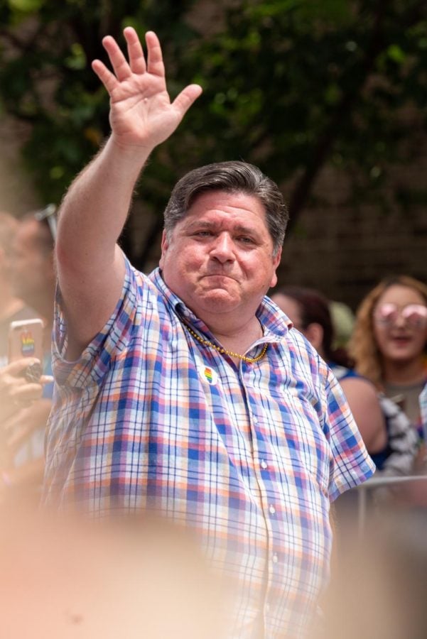 Governor+J.B.+Pritzker+waves+to+the+crowd+as+he+participates+in+Sunday%27s+pride+parade.