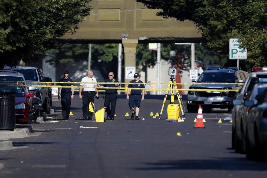Authorities walk among evidence markers at the scene of a mass shooting, Sunday, Aug. 4, 2019, in Dayton, Ohio. Severral people in Ohio have been killed in the second mass shooting in the U.S. in less than 24 hours, and the suspected shooter is also deceased, police said.