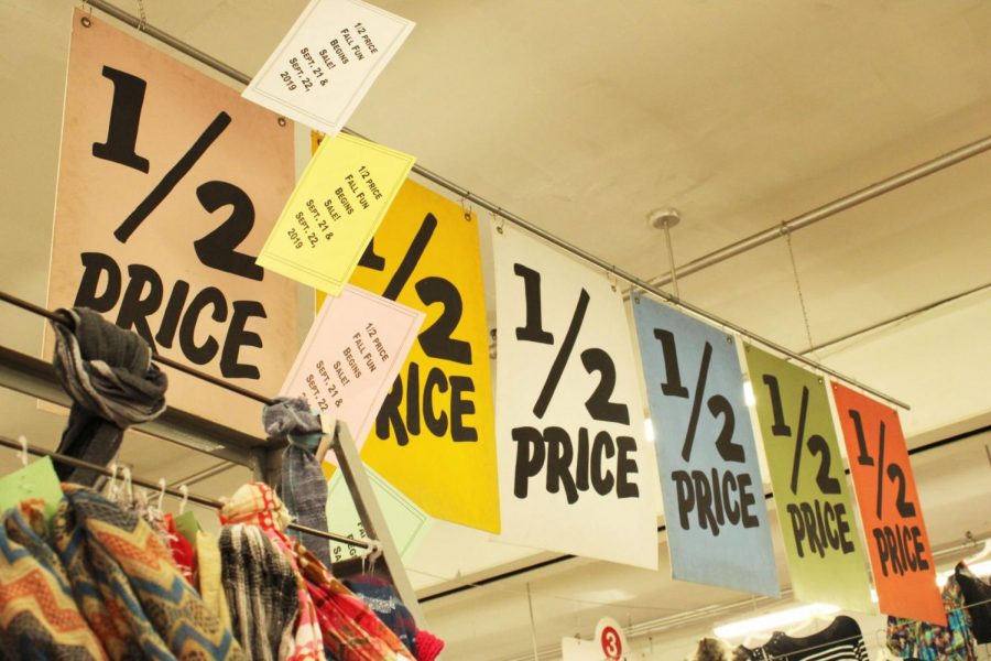 Color-coded sales are noted at the entrance of Village Discount Outlet.