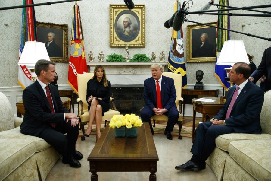 President Donald Trump talks about a plan to ban most flavored e-cigarettes, in the Oval Office of the White House, Wednesday, Sept. 11, 2019, in Washington. From left, acting FDA Commissioner Ned Sharpless, first lady Melania Trump, Trump, and Secretary of Health and Human Services Alex Azar.