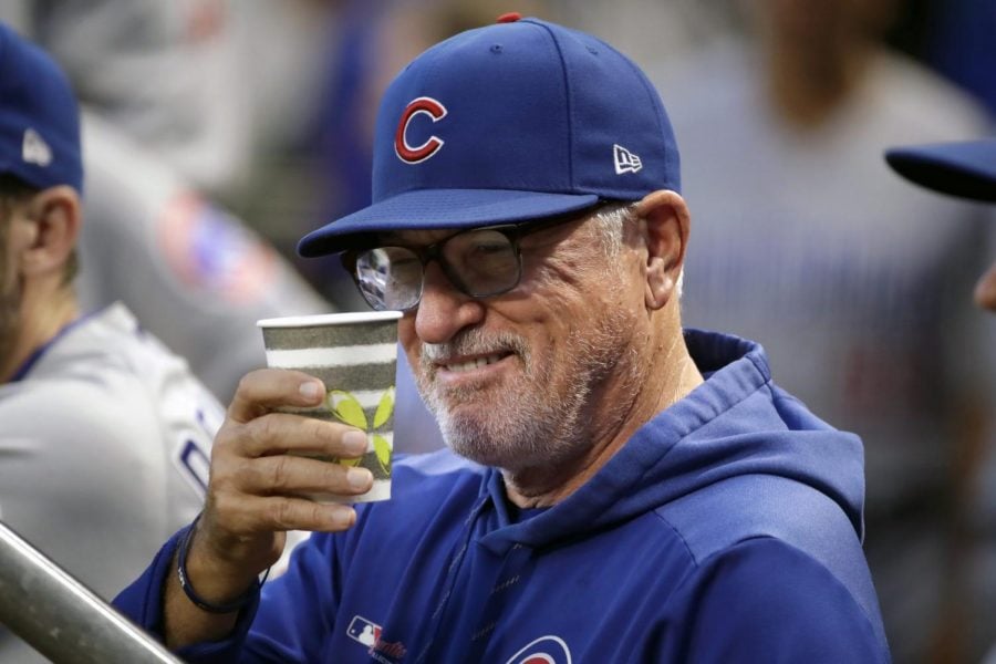 Chicago Cubs manager Joe Maddon salutes a fan from the dugout before a baseball game against the Pittsburgh Pirates in Pittsburgh, Wednesday, Sept. 25, 2019.
