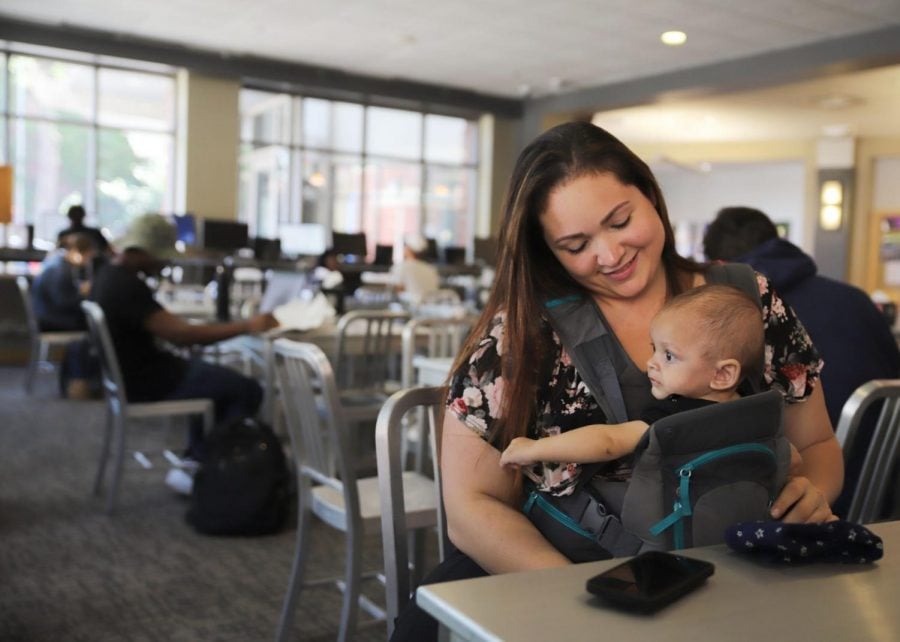 Liz Arendt sits in DePaul’s Student Center in Lincoln Park with her newborn, Azrael. After posponing treatment during pregnancy, Arendt is now balancing treatment, motherhood and four classes. 