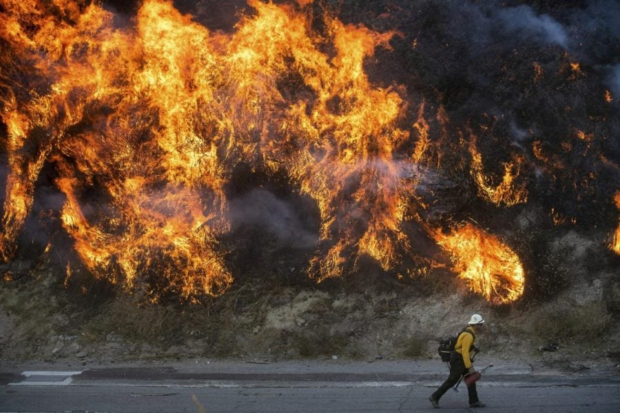 Flames from a backfire, lit by firefighters to stop the Saddleridge Fire from spreading, burn a hillside in Newhall, Calif., on Friday, Oct. 11, 2019.