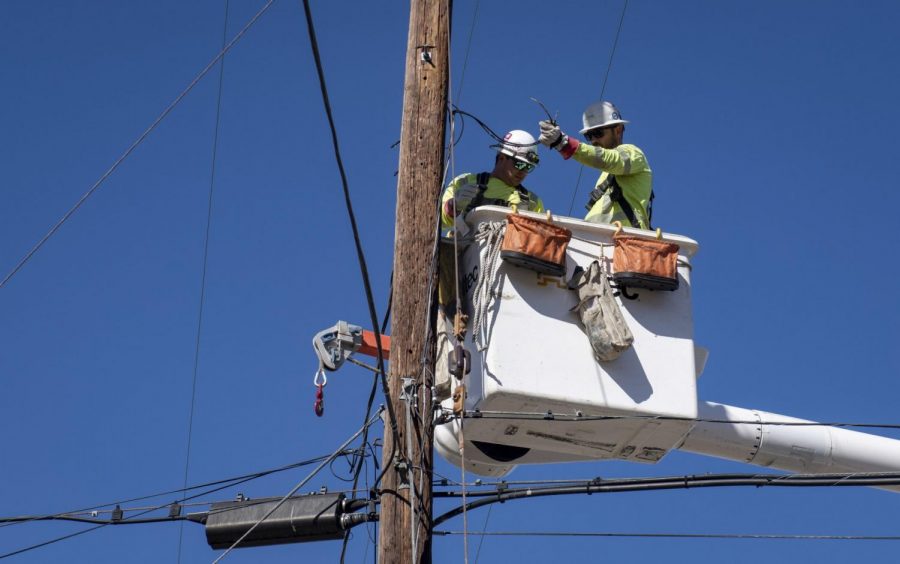 SoCal Edison crews replace power lines that were damaged from the Tick Fire, Thursday, Oct. 25, 2019, in Santa Clarita, Calif. An estimated 50,000 people were under evacuation orders in the Santa Clarita area north of Los Angeles as hot, dry Santa Ana winds howling at up to 50 mph (80 kph) drove the flames into neighborhoods (AP Photo/ Christian Monterrosa)from the Tick Fire, Thursday, Oct. 25, 2019, in Santa Clarita, Calif. An estimated 50,000 people were under evacuation orders in the Santa Clarita area north of Los Angeles as hot, dry Santa Ana winds howling at up to 50 mph (80 kph) drove the flames into neighborhoods.