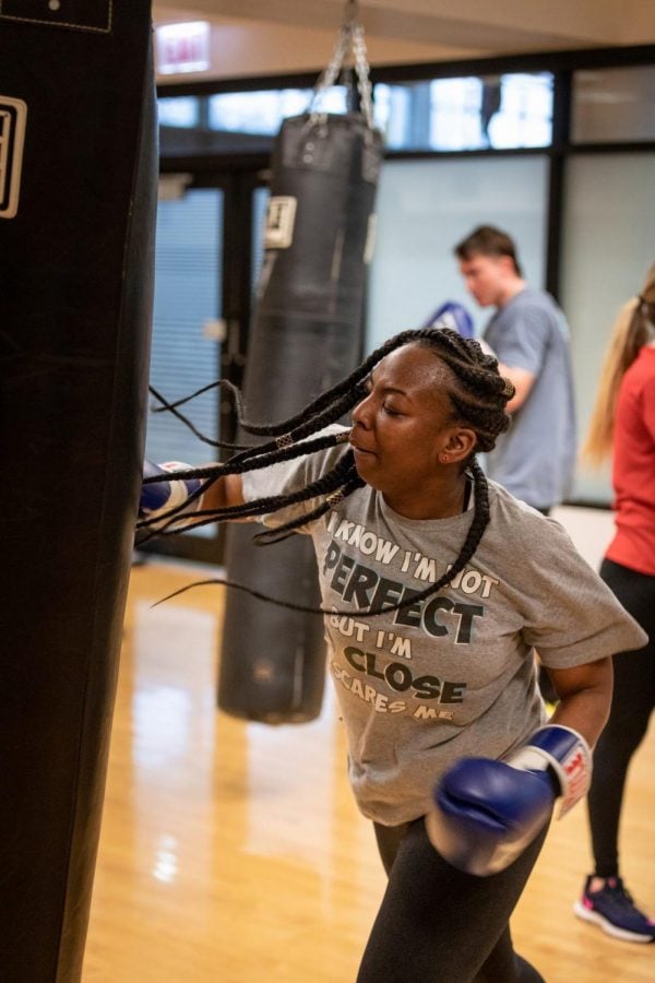 A student partakes in a boxing class.