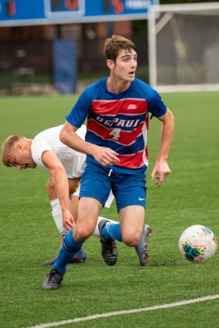 DePaul freshman defender Dan Iscra dribbles past a Vermont defender during a match on Sep. 1 at Wish Field. The Blue Demons lost the game 1-0.