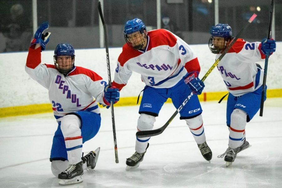 DePaul winger Connor McNally (left) celebrates with teammates after scoring a goal against Illinois in the second period on Friday.