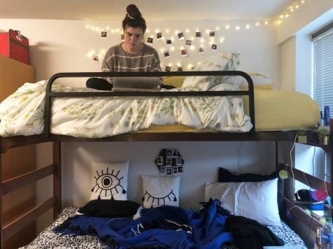 FILE PHOTO—Kassidy Kascht sits in her bunk doing homework in her converted housing unit in Clifton-Fullerton Hall. Kascht’s room was designed to house two students, but currently houses three freshmen. 