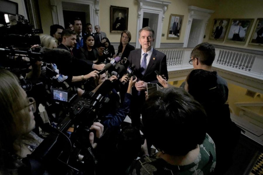 Virginia Giovernor Ralph Northam, center, is surrounded by media outside his office at the State Capitol in Richmond, Va., Wednesday, Nov. 6, 2019. Northam had just left a meeting with his Cabinet and was questioned about the previous nights election results which gave Democrats control of the Virginia House of Delegates and Senate.