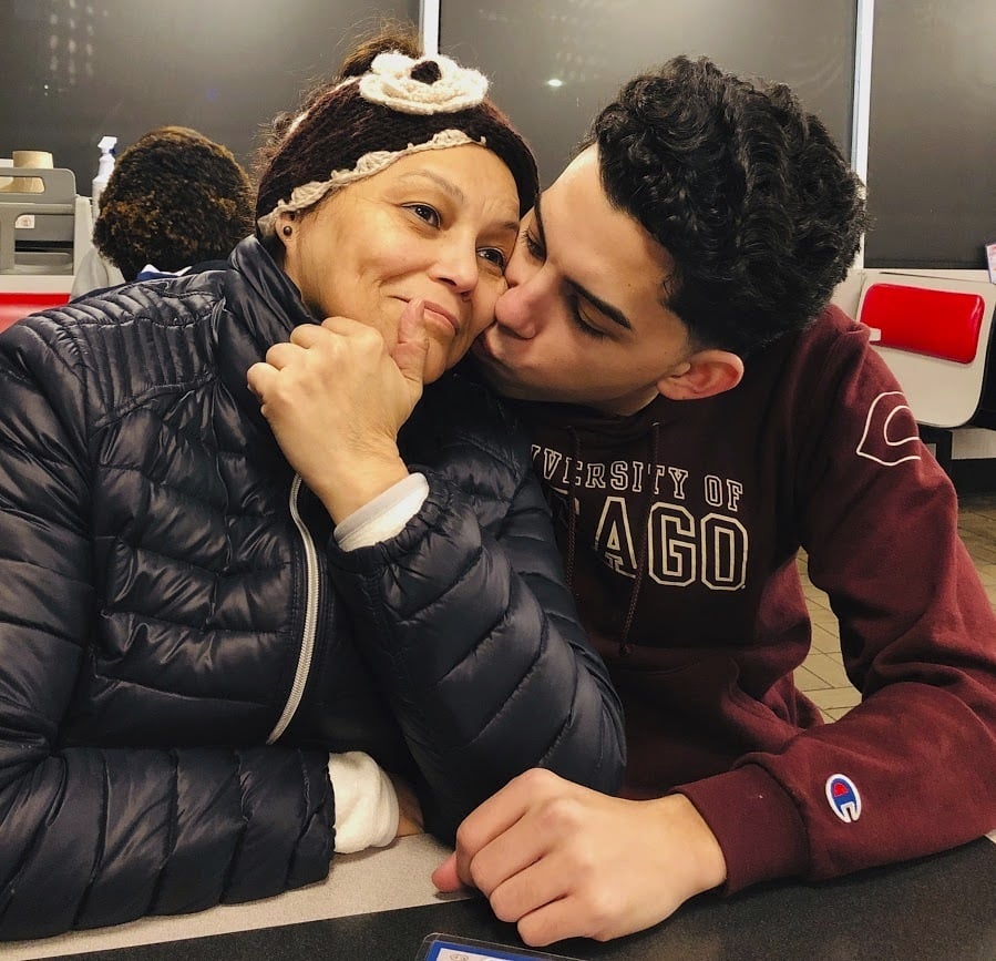 This photo provided by Cristian Padilla Romero, Tania Romero, left, is kissed by her son, Cristian Padilla Romero, in an Atlanta restaurant in 2019. The Yale University graduate student is trying to prevent the deportation of his mother to Honduras, a country where he says she wont get the medical treatment she needs as a survivor of stage-four cancer. (Cristian Padilla Romero via AP)