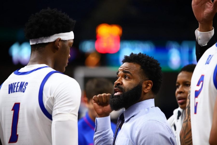 DePaul interim head coach Tim Anderson talks with freshman forward Romeo Weems during DePaul’s game against the University of Chicago on Wednesday at Wintrust.