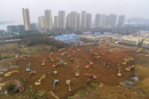 In this Friday, Jan. 24, 2020, file photo, heavy equipment works at a construction site for a field hospital in Wuhan in central China's Hubei Province. A patient in Southern California is third person in the U.S. to be diagnosed with the new pneumonia-like virus from China, health officials said.