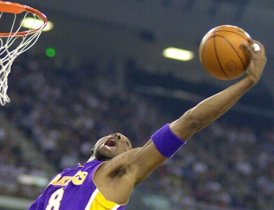 In this May 13, 2001 file photo Los Angeles Lakers Kobe Bryant reaches back for a rebound during the first half of game four of the Western Conference semifinals against the Sacramento Kings in Sacramento, Calif. Bryant, a five-time NBA champion and a two-time Olympic gold medalist, died in a helicopter crash in California on Sunday, Jan. 26, 2020. He was 41.