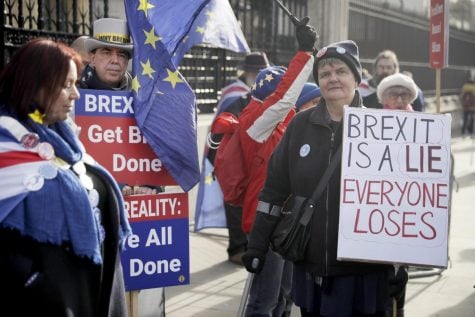 Anti-Brexit remain in the European Union supporter Steve Bray, second left, protests outside the Houses of Parliament to coincide with the weekly Prime Minister’s Questions at the Houses of Parliament, in London, Wednesday, Feb. 5, 2020.