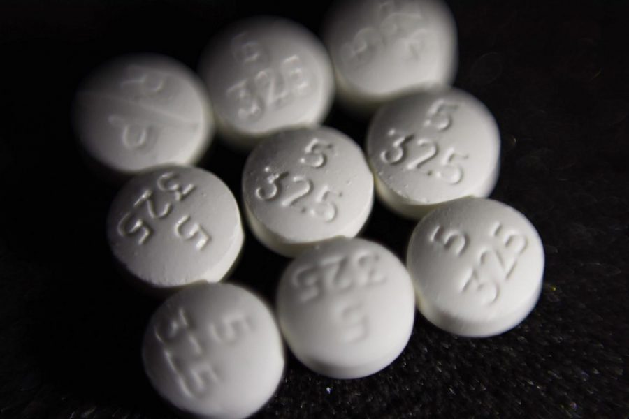 This Aug. 15, 2017 file photo shows an arrangement of pills of the opioid oxycodone-acetaminophen, also known as Percocet, in New York. Dozens of Ohio local government leaders gathered privately Tuesday, Feb. 11, 2020, to discuss how to divide millions of dollars from a prospective opioid settlement. The goal is to position themselves to enter settlement talks with drugmakers as a united front with the state, which would be a first nationally.
