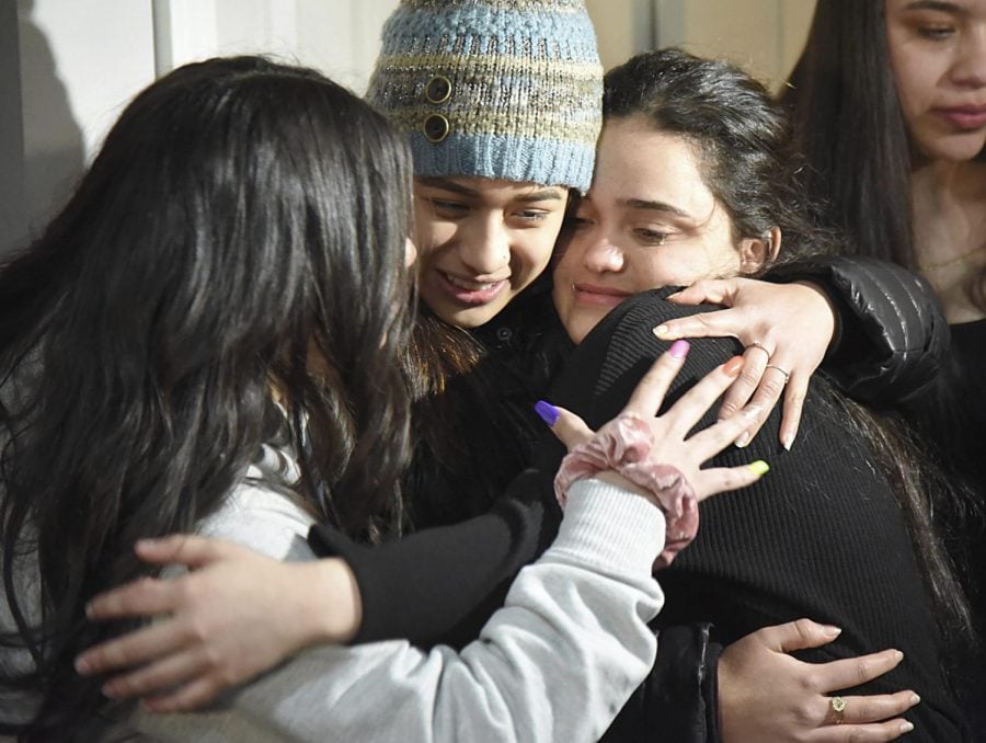 Meydi Guzman, right, a Crystal Lake Central High School senior who was in U.S. Immigration and Customs custody for several months, embraces friends as she is welcomed back at the home of school counselor Sara Huser on Thursday, Feb. 13, 2020, in Crystal Lake, Ill. Guzamans supporters plan to continue a fight against her deportation to Honduras.