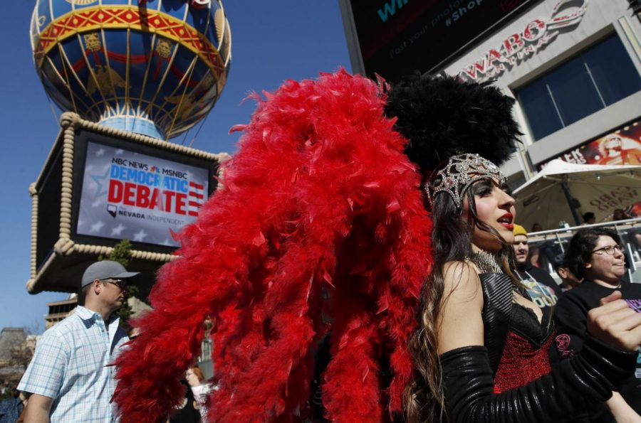 In this Feb. 19, 2020, file photo, people dressed as showgirls walk near the Paris Las Vegas hotel casino, site of a Democratic presidential debate, in Las Vegas. If Nevada has one job in the Democratic primary, its to offer something different. And in many ways it has delivered. As the presidential race turned to the state this week, gone was the earnestness of Iowa and tradition of New Hampshire and in its place was racial diversity, a new unpredictability and the muscle of urban, union politics.