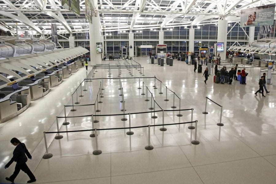 People visit an international terminal at John F. Kennedy airport, Friday, March 13, 2020, in New York. A ban on travelers from most European countries begins at midnight Friday, and travelers returning from there will be screened. The ban is the latest calamity for a global travel industry already reeling from falling bookings and canceled reservations as people try to avoid contracting and spreading the coronavirus.