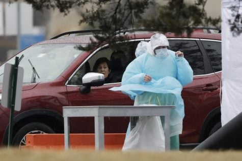 Medical personnel at Advocate Lutheran General Hospital, conduct drive-thru COVID-19 testing in Park Ridge, Ill., Wednesday, March 18, 2020.