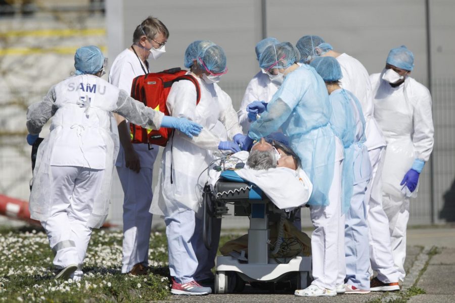 A victim of the Covid-19 virus is evacuated from the Mulhouse civil hospital, eastern France, Monday March 23, 2020. The Grand Est region is now the epicenter of the outbreak in France, which has buried the third most virus victims in Europe, after Italy and Spain. For most people, the new coronavirus causes only mild or moderate symptoms. For some it can cause more severe illness.