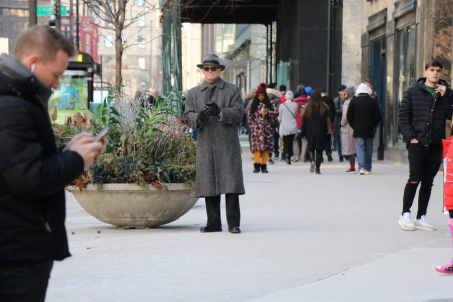 A man pauses on the street.