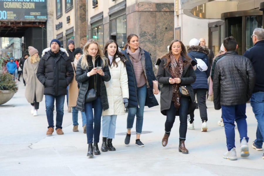 A group of women walk down Michigan Ave. near Nordstroms.