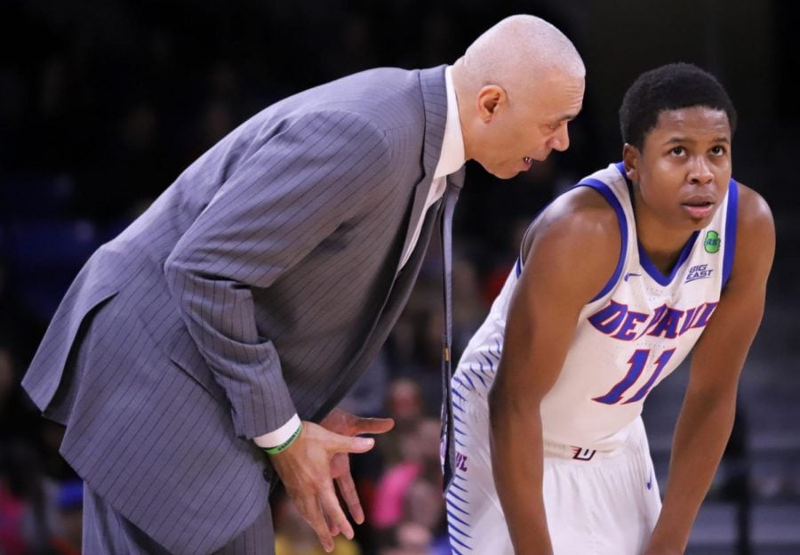 DePaul head coach Dave Leitao talks to junior guard Charlie Moore during the Blue Demons 74-68 win over Georgetown on Feb. 22.