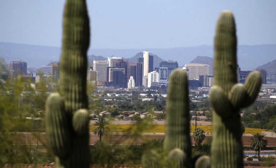 Framed by saguaro cactus, the downtown Phoenix skyline is easier to see, Tuesday, April 7, 2020, as fewer motorists in Arizona are driving, following the state stay-at-home order due to the coronavirus, and it appears to be improving the air quality and decreasing the effects vehicle emissions have on the environment.