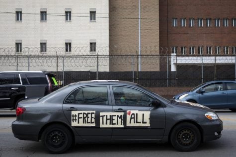 In this April 7, 2020 file photo, amid fears of the coronavirus pandemic, dozens of protesters drive around Cook County Jail and the Leighton Criminal Courthouse in Chicago, honking their horns and chanting to demand the