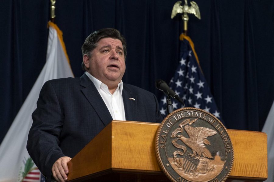 Illinois Gov. J.B. Pritzker, along with other health officials, gives a daily update on the coronavirus outbreak in Illinois, Monday, April 13, 2020, in Chicago.