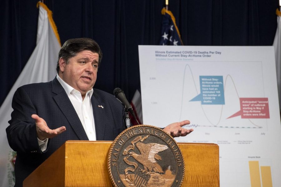 In this April 23, 2020 file photo, Gov. J.B. Pritzker announces an extension of the stay at home order for Illinois as well as a mandatory face covering order at his daily Illinois coronavirus update at the Thompson Center. Illinois State Rep. Darren Bailey, R-Xenia filed suit against the order, and a judge in southern Illinois ruled Monday, April 27, 2020, that the Illinois governors order to stem the spread of the coronavirus exceeds his emergency authority and violates individual civil rights.