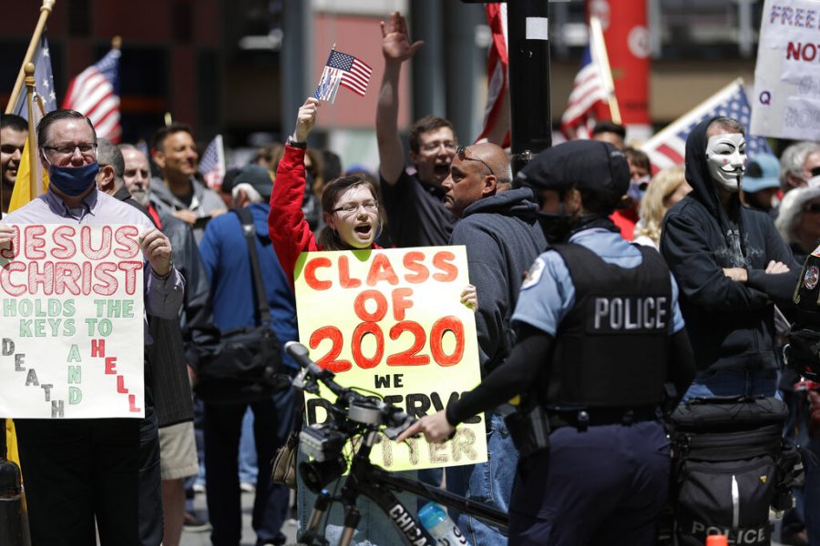 Reopen Illinois protesters rally outside Thompson Center in downtown Chicago, Saturday, May 16, 2020, during the coronavirus pandemic. (AP Photo/Nam Y. Huh)
