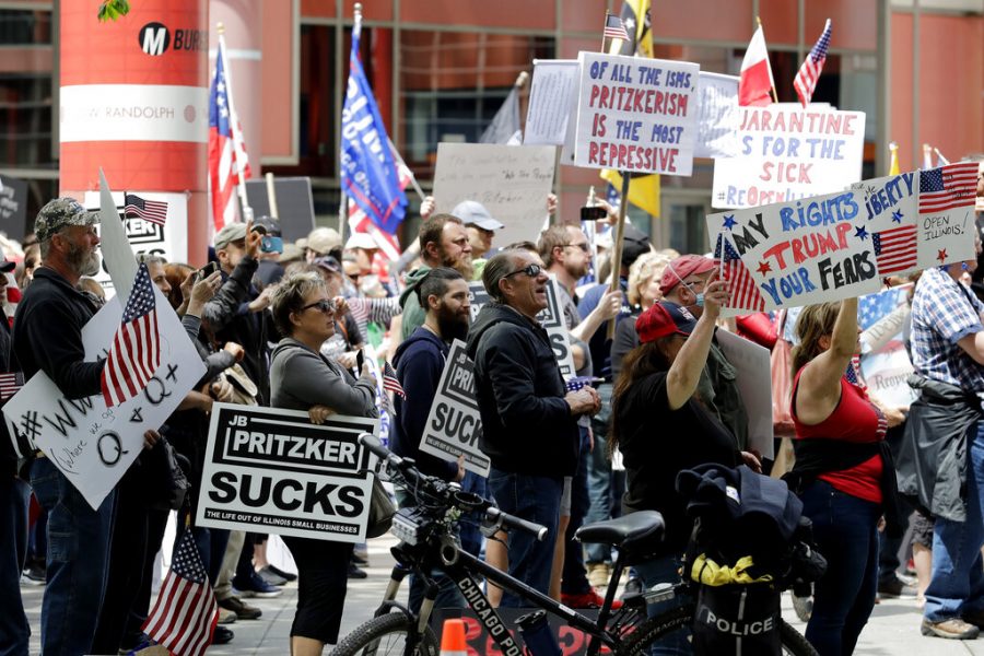 Protesters rally outside the Thompson Center in downtown Chicago, calling for Gov. J.B. Pritzker to reopen Illinois, Saturday, May 16, 2020. (AP Photo/Nam Y. Huh)