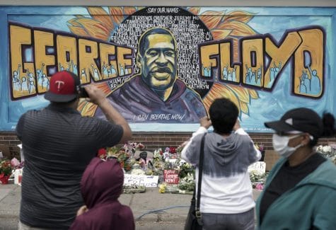 People gather on Friday May 29 at a memorial mural painted outside the Cup Foods store on Chicago Avenue in South Minneapolis where George Floyd died at the hands of police.