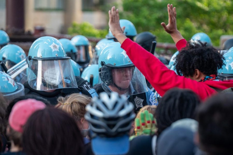 FILE-Officers+attempt+to+block+protesters%2C+including+one+with+their+hands+up.