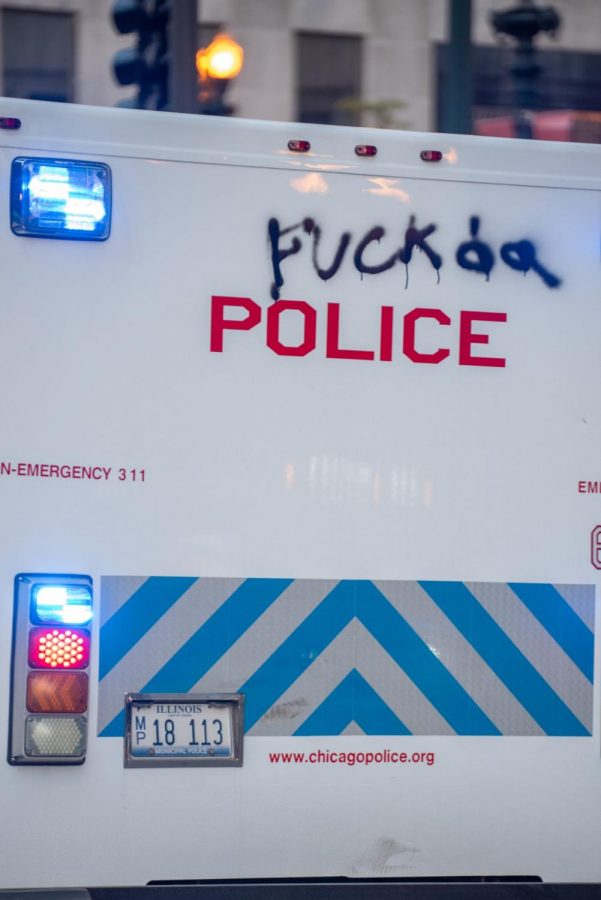 A police vehicle bearing graffiti.