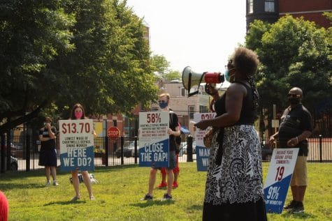 Le'Denise Henderson, a Chartwells barista who was laid off, speaks to protesters.