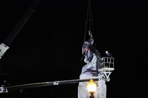 The Christopher Columbus statue located in Grant Park is removed at early Friday morning.