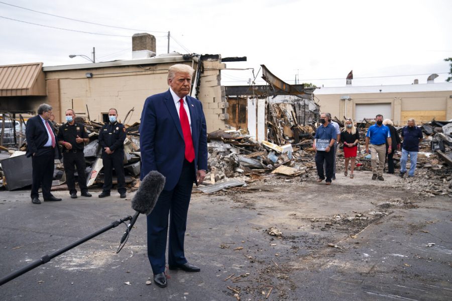 President Donald Trump tours an area on Tuesday, Sept. 1, 2020, damaged during demonstrations after a police officer shot Jacob Blake in Kenosha, Wis. (AP Photo/Evan Vucci)