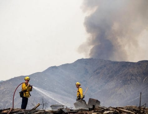 Fountain Valley, Caif., firefighters extinguish hot spots at a structure destroyed by the El Dorado wildfire on Monday, Sept. 7, 2020, near Yucaipa, Calif. A couple's plan to reveal their baby's gender went up not in blue or pink smoke but in flames when the device they used sparked a wildfire east of Los Angeles. The fire started Saturday morning in dry grasses at El Dorado Ranch Park, a rugged natural area in the city of Yucaipa. (Cindy Yamanaka/The Orange County Register/SCNG via AP)